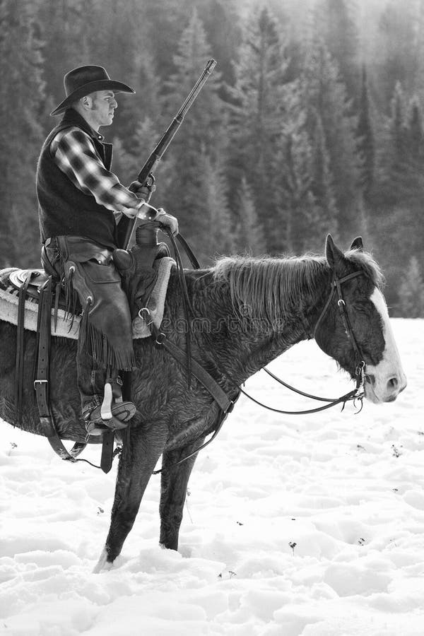 Black and White Photograph Of ranch hand with repeating rifle