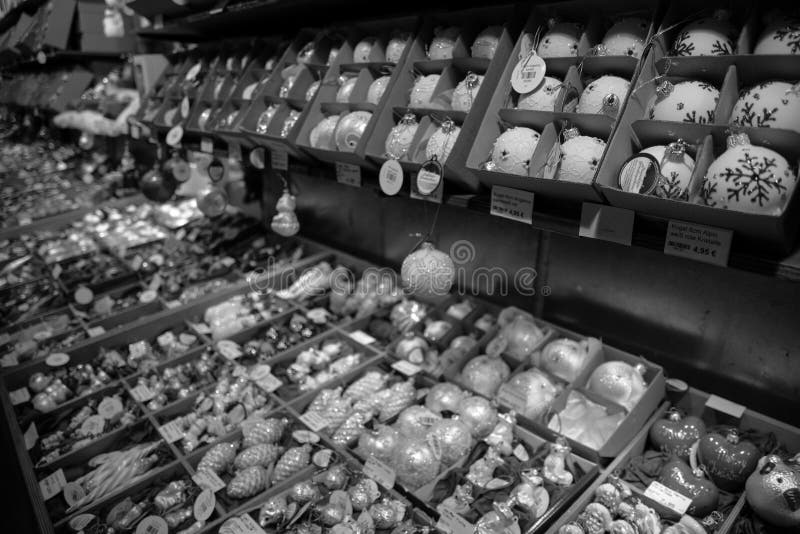 Black and white photography of rows of handmade glass Christmas ornaments of various shapes in boxes on shelves at Christmas fair stock images Black and white photography of rows of handmade glass Christmas ornaments of various shapes in boxes on shelves at Christmas fair stock images