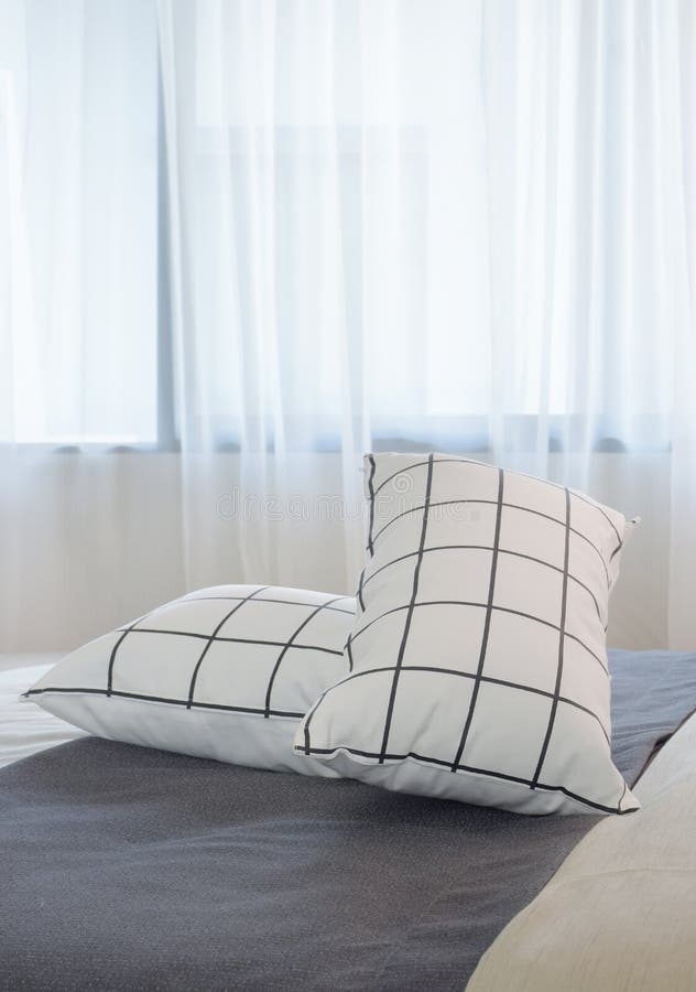 Black and White Pillows Setting on Dark Gray Bed Runner Stock Image