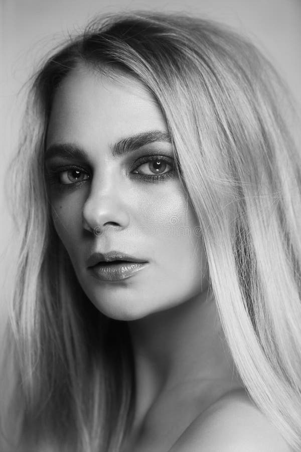 Black and white portrait of beautiful woman with smoky eye make-up