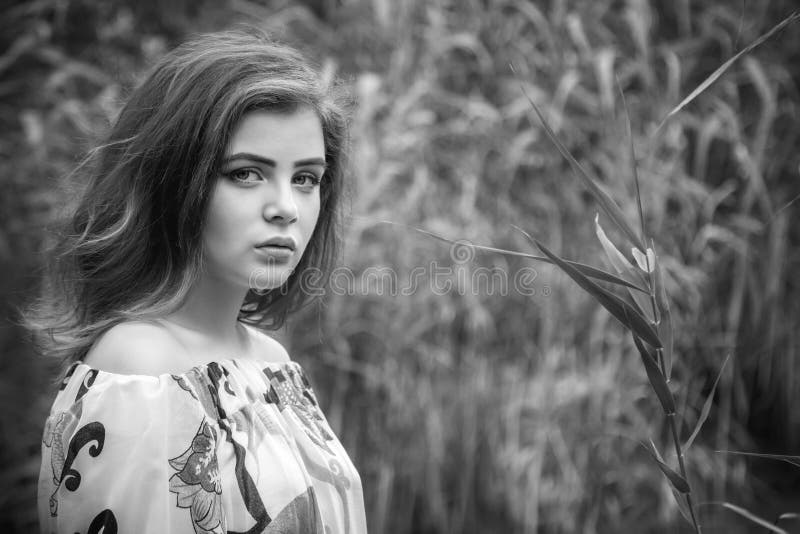 Black and white portrait of beautiful young sad brunette woman