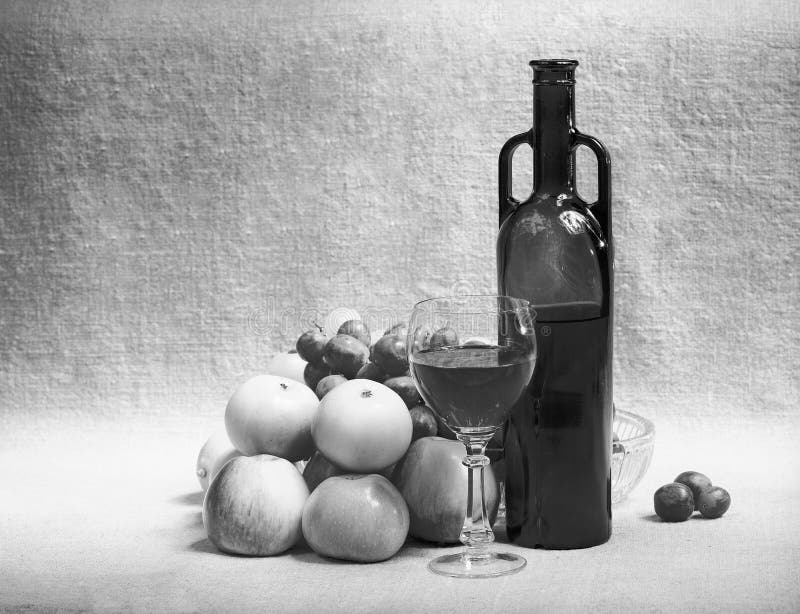 Black and white still-life with wine and fruit