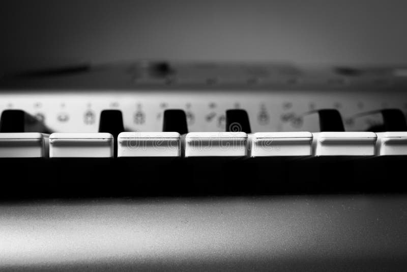 Black and white synthesizer keys, front view, selective focus stock photography