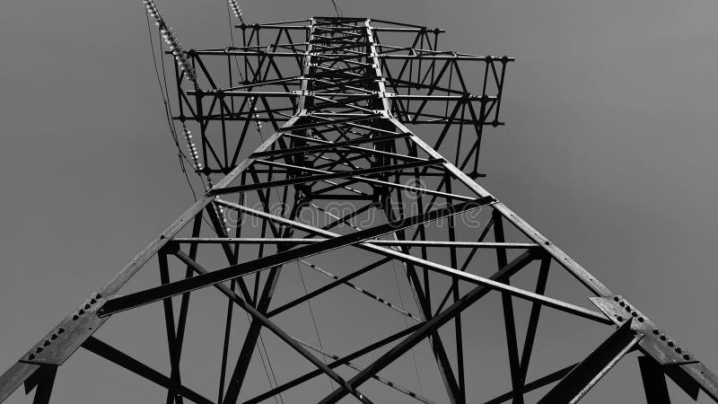 Black and white video of metal electric tower of high voltage. Close-up view.