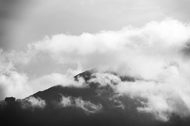 Black and white view of a mountain peak covered with clouds in Tatra National park in Slovakia