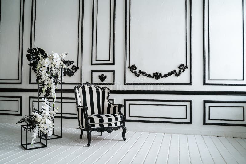 Black and White Wall Decoration with Armchair and Flowers Stock Image
