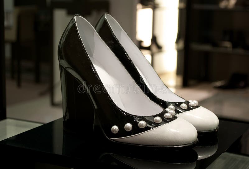 Chanel Black and white women shoes with a pearls .The high heels and the biggest part is in black lacquer and the tip is in White leather...classic and modern in a same time...