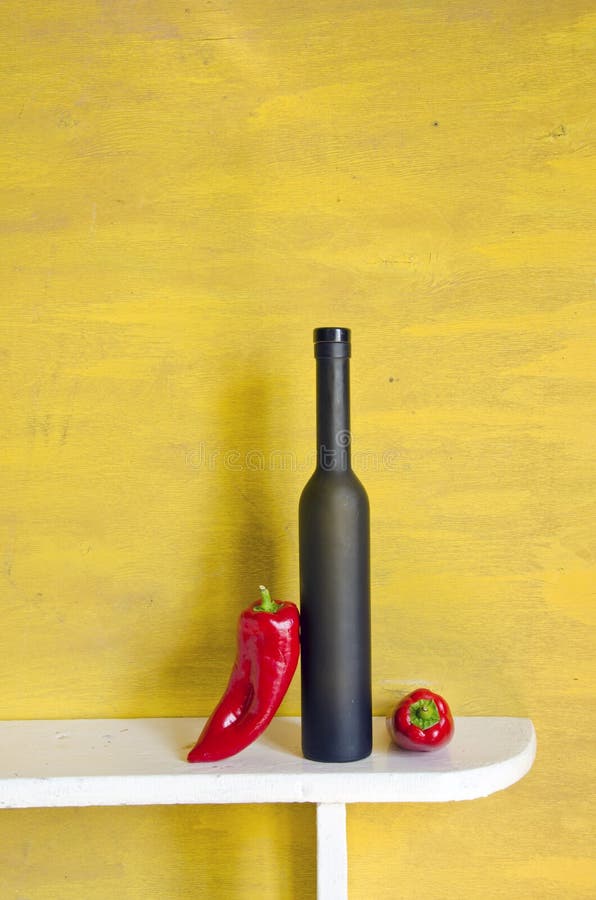 Black wine bottle and red peppers