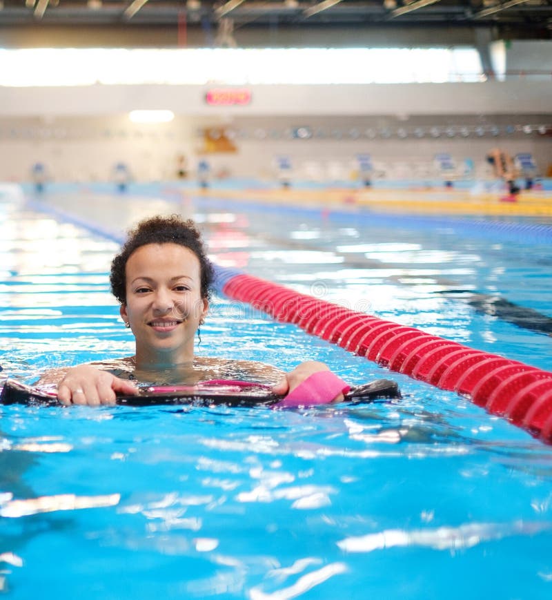 Black woman attending water aerobics class in a swimming pool stock photos Black woman attending water aerobics class in a swimming pool stock photos