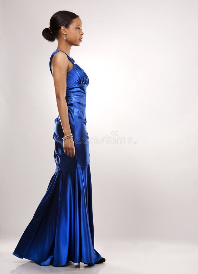 same-quail770: a black woman wearing a shiny navy blue dress with