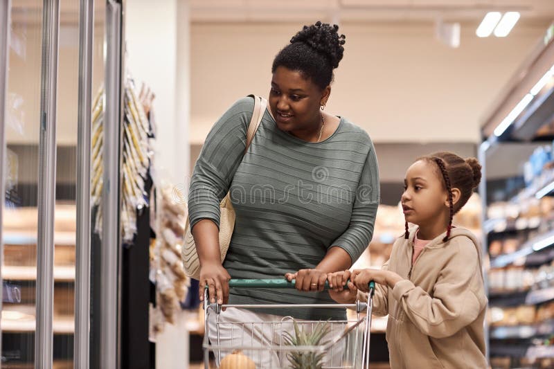 Black Woman in Supermarket Shopping for Groceries with Little Girl ...