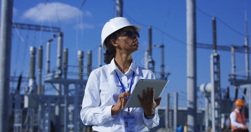 Black woman with tablet working on solar plant stock photo