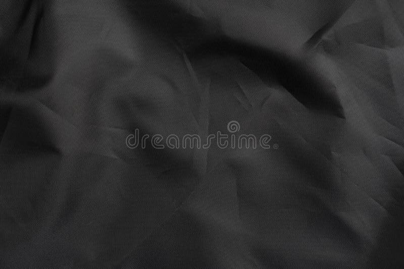 Black wrinkled material with wrinkles and contrasting texture stock photography