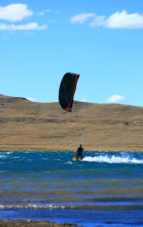 Blackred kitesurfer cruising