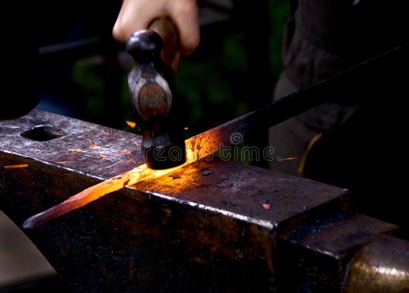 Blacksmith hammering hot metal