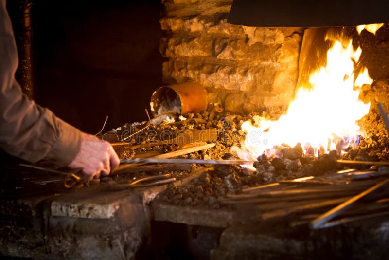 Blacksmith Heating a Metal Rod Stock Image Image of metalwork, hammer