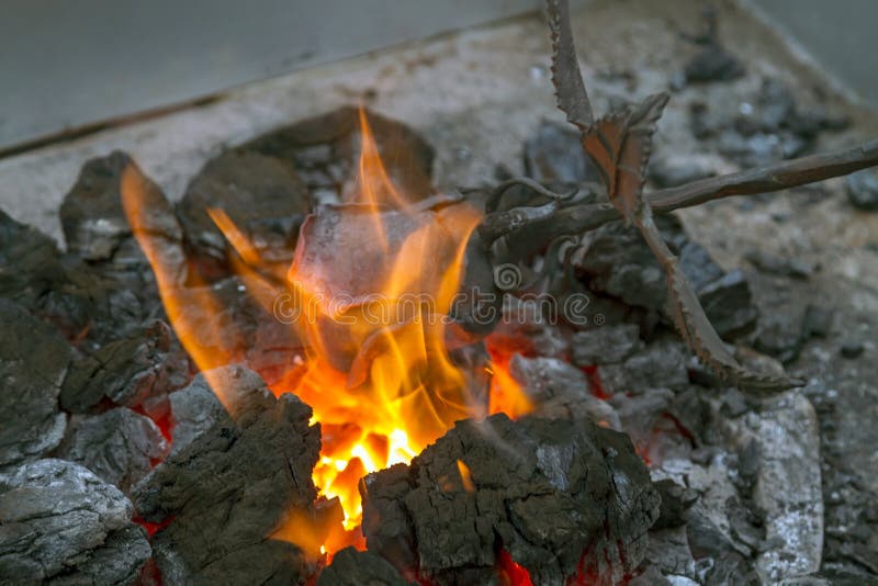 Blacksmith heating up iron stock photo. Image of melting 35071390