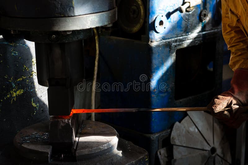 The Blacksmith Manually the Molten Metal on the Anvil Stock