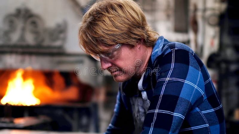 Blacksmith using laptop in workshop stock video footage