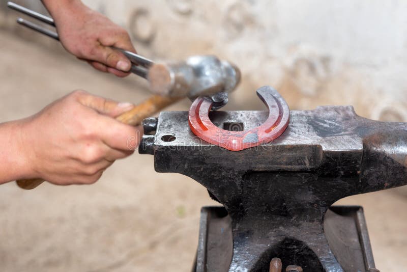 Blacksmith Working on the Anvil, Making a Horseshoe. Stock Image