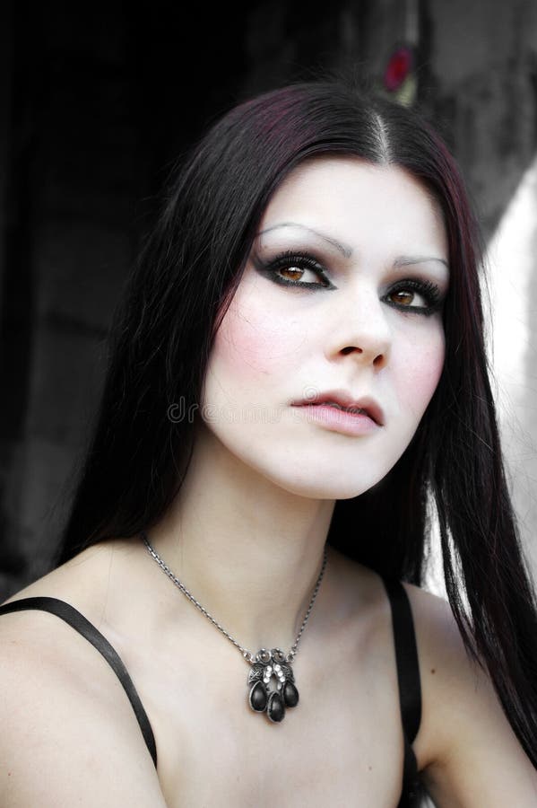 Gothic pale skin woman in cemetery close-up. Gothic pale skin woman in cemetery close-up