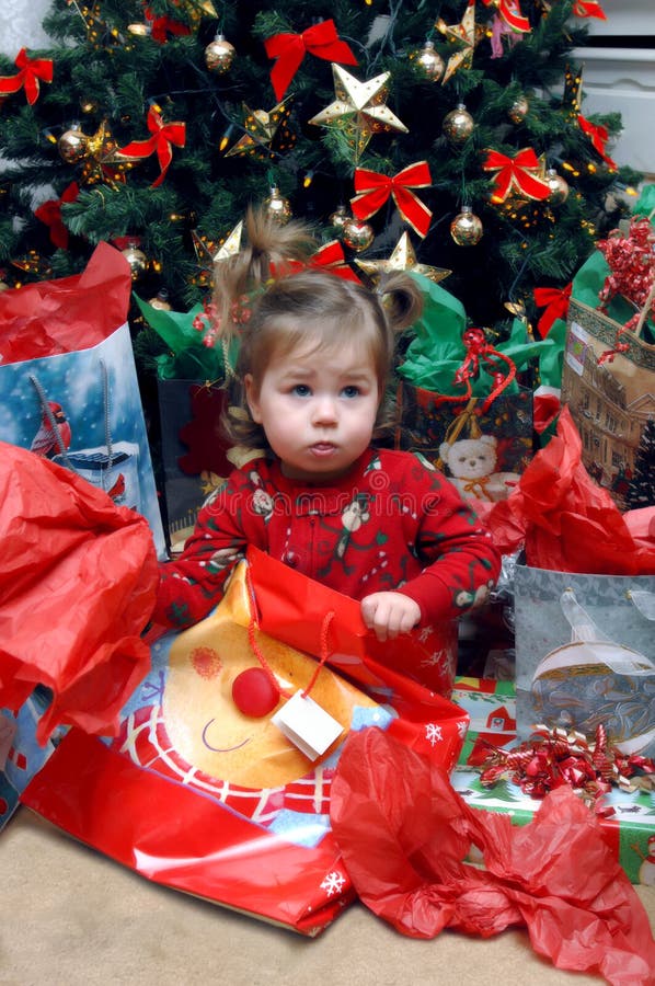 It is not in there! Little toddler looks disappointed in the contents of her Christmas bag! She is still wearing her Christmas morning pajamas and holding open a decorative gift bag. It is not in there! Little toddler looks disappointed in the contents of her Christmas bag! She is still wearing her Christmas morning pajamas and holding open a decorative gift bag.
