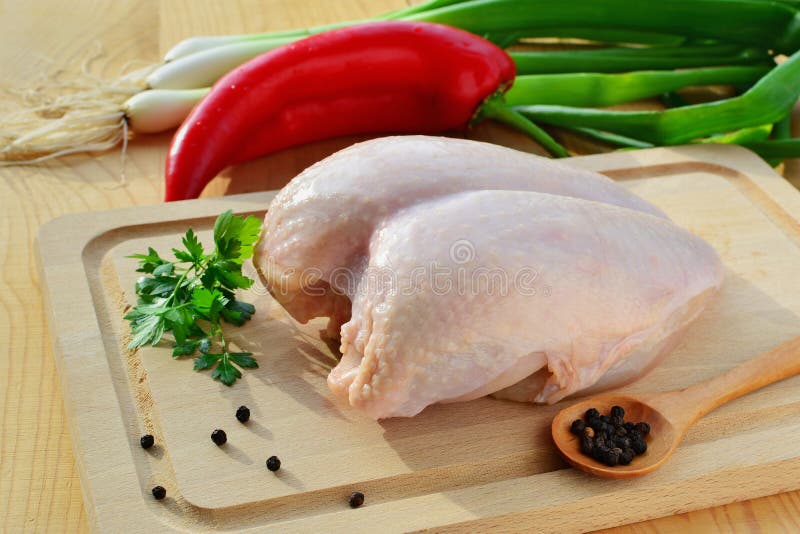 Blanc de poulet cru avec la peau et les légumes photo stock Blanc de poulet cru avec la peau et les légumes photo stock