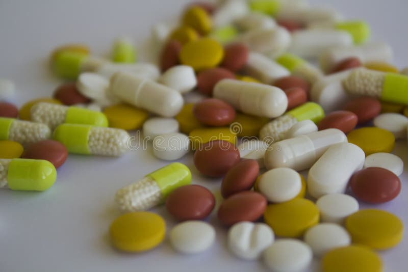 Blandade medicinska preventivpillerar på en vit bakgrund arkivbilder Blandade medicinska preventivpillerar på en vit bakgrund arkivbilder