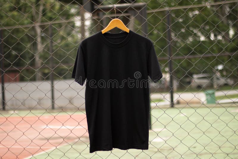 Black t-shirt on wood hanger in outdoor suitable for mockup