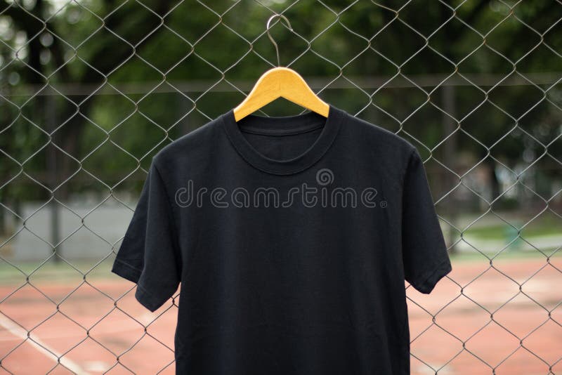 Black t-shirt on wood hanger in outdoor