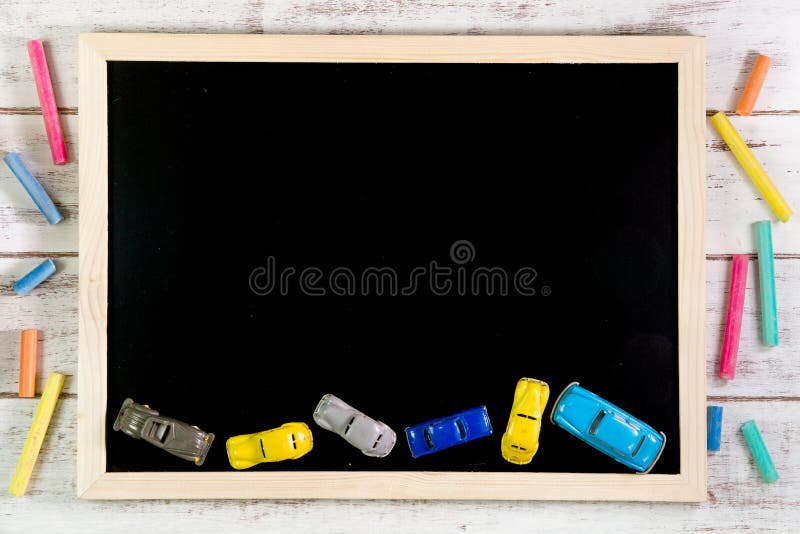 Blank blackboard and Car toys on wooden table. Template mock up f stock photos