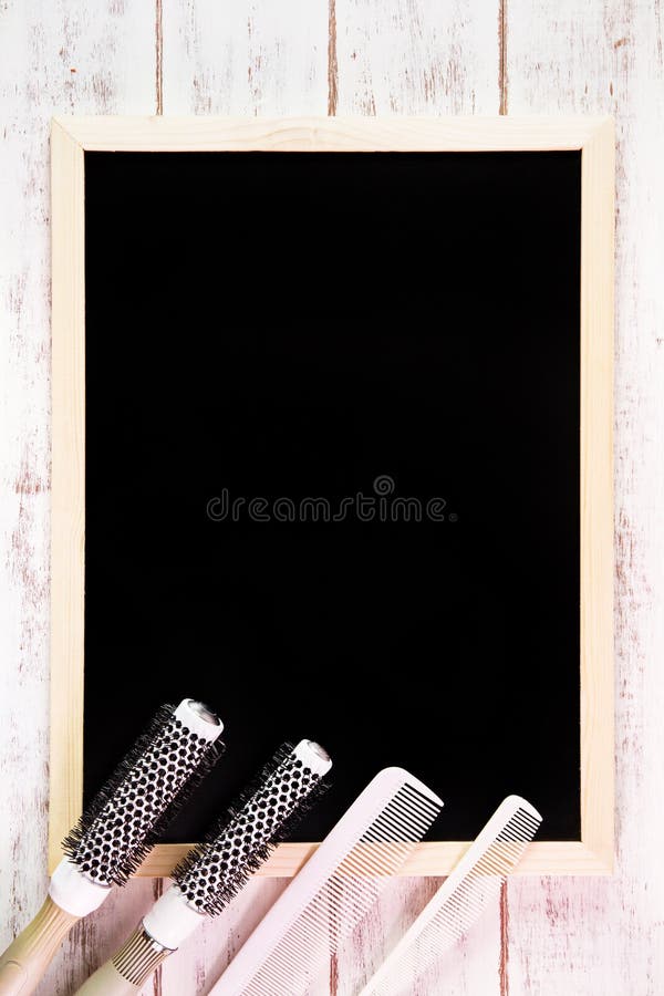 Blank blackboard and Hairdresser's comb on wooden table. Template stock image