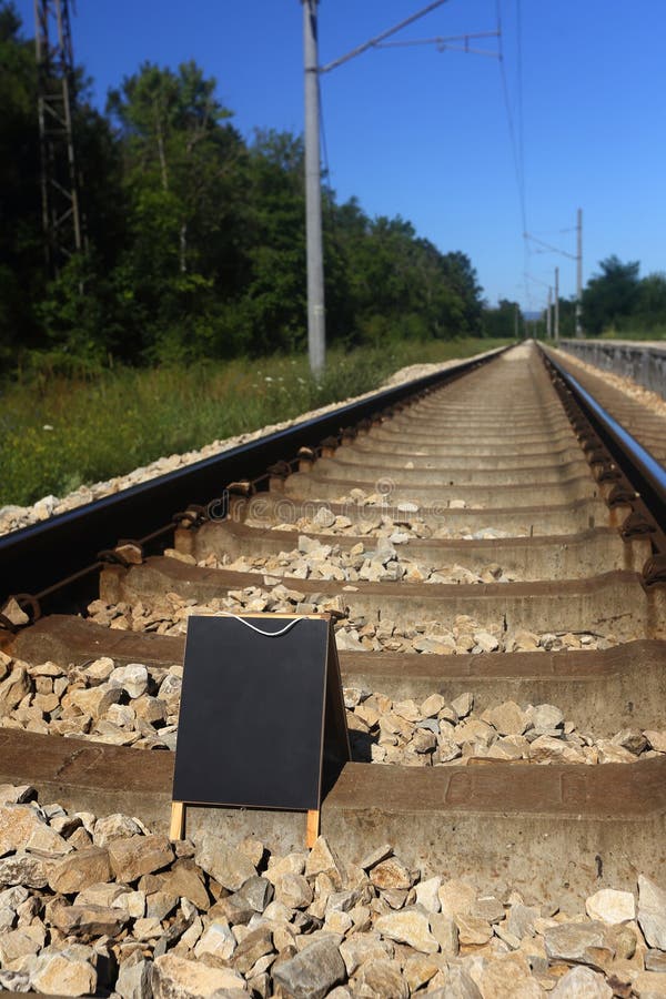 Blank blackboard on the railroad royalty free stock photo