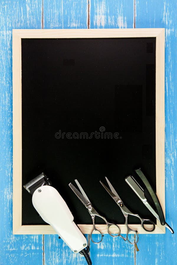 Blank blackboard, Scissors hairdresser and Clipper Barber on woo stock image