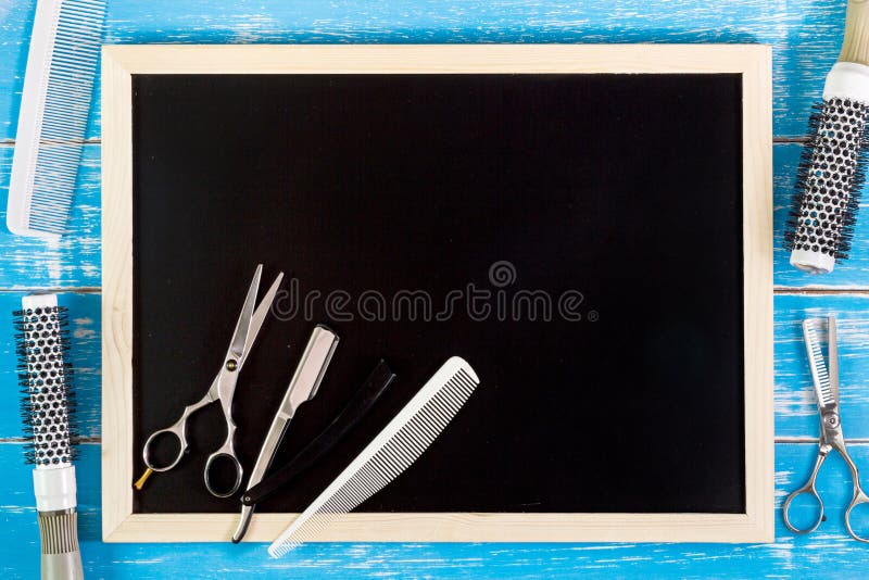 Blank blackboard and scissors hairdresser set with various accessories on wooden table. Template mock up for adding your design stock images