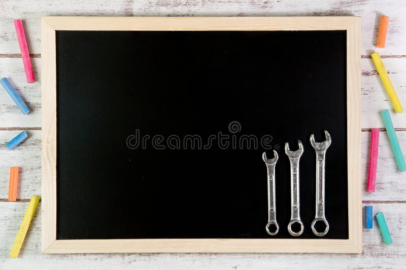 Blank blackboard and Set of wrench on wooden table. Template mock royalty free stock photo