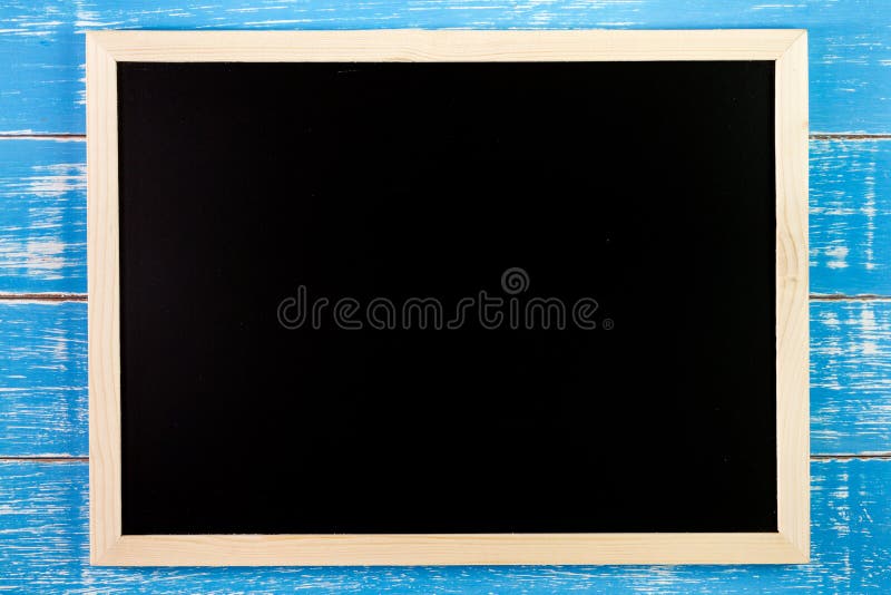Blank blackboard on wooden table. Template mock up for adding you royalty free stock photo