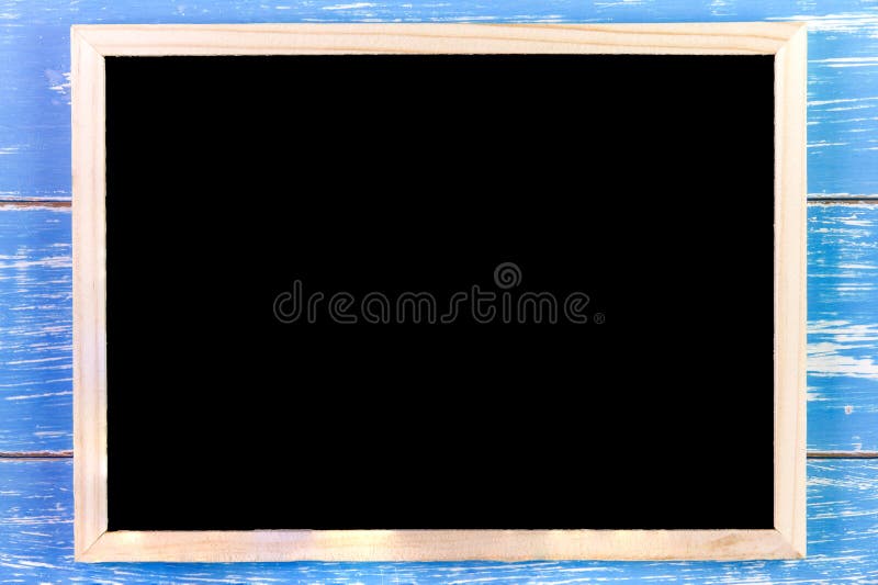 Blank blackboard on wooden table. Template mock up for adding you royalty free stock image