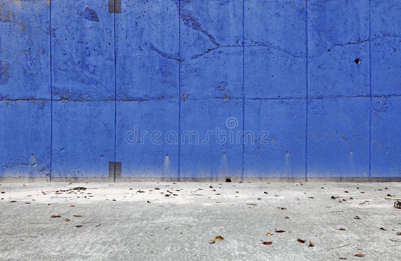 A blank blue color grungy concrete wall for textural background. A blank blue color grungy concrete wall for textural background.