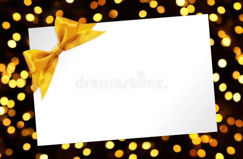 Blank Card with bow in golden lights background. Blank Card with bow in golden lights glitter background royalty free stock image