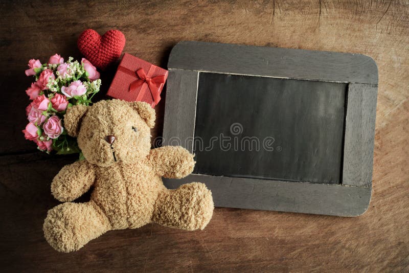 Blank chalkboard with teddy bear and flowers stock photos
