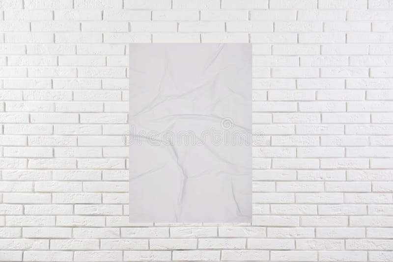 Blank Creased Poster on White Brick Wall. Mockup for Design Stock Image