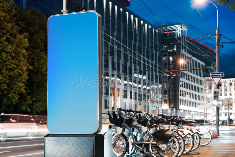 Blank illuminated white outdoor banner stand at night time in the city royalty free stock image Blank illuminated white outdoor banner stand at night time in the city royalty free stock image