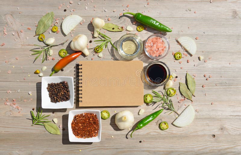 Blank Notebook For Notes And Pepper, Bay Leaf, Rosemary, Onions, Himalayan Salt, Olive Oil, Soy Sauce On A Wooden