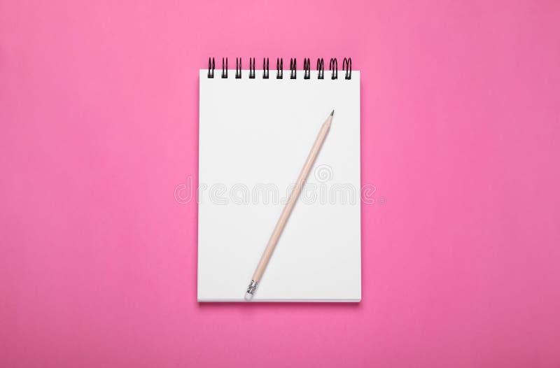 Blank notebook and pencil on pink background stock images
