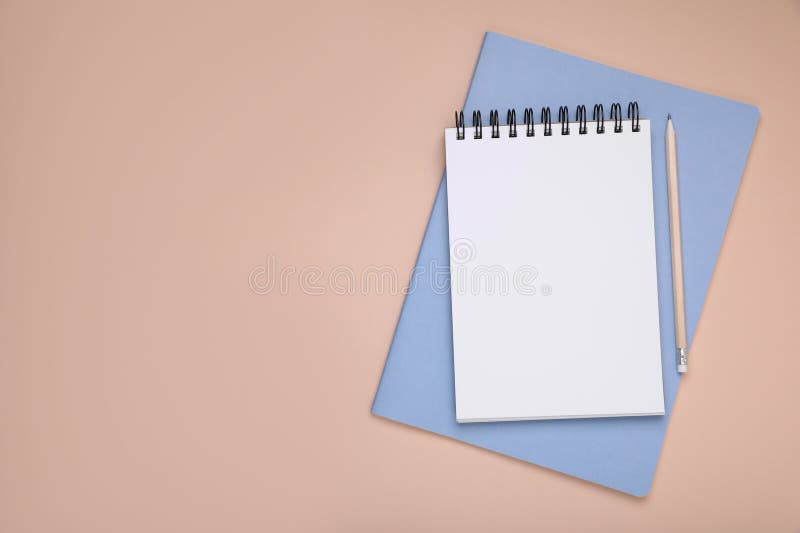 Blank notebook, planner and pencil on beige background, top view. Space for text royalty free stock images