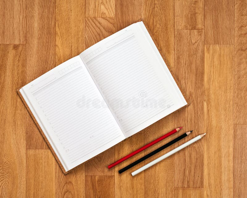 Blank notepad with office supplies on wooden table.