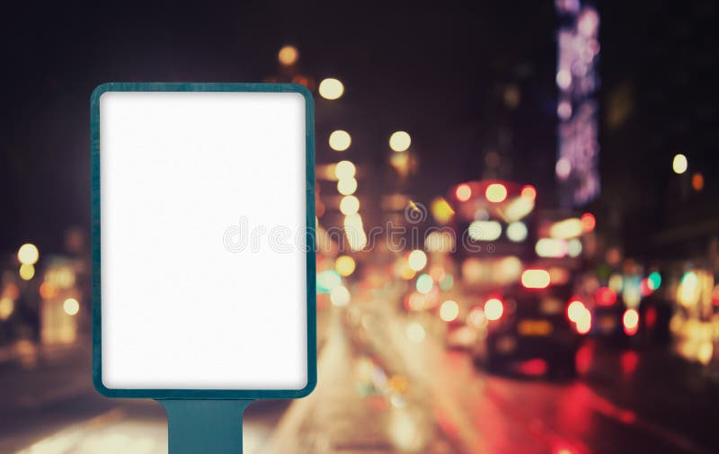 Blank outdoor billboard mockup on city street at night with traffic lights