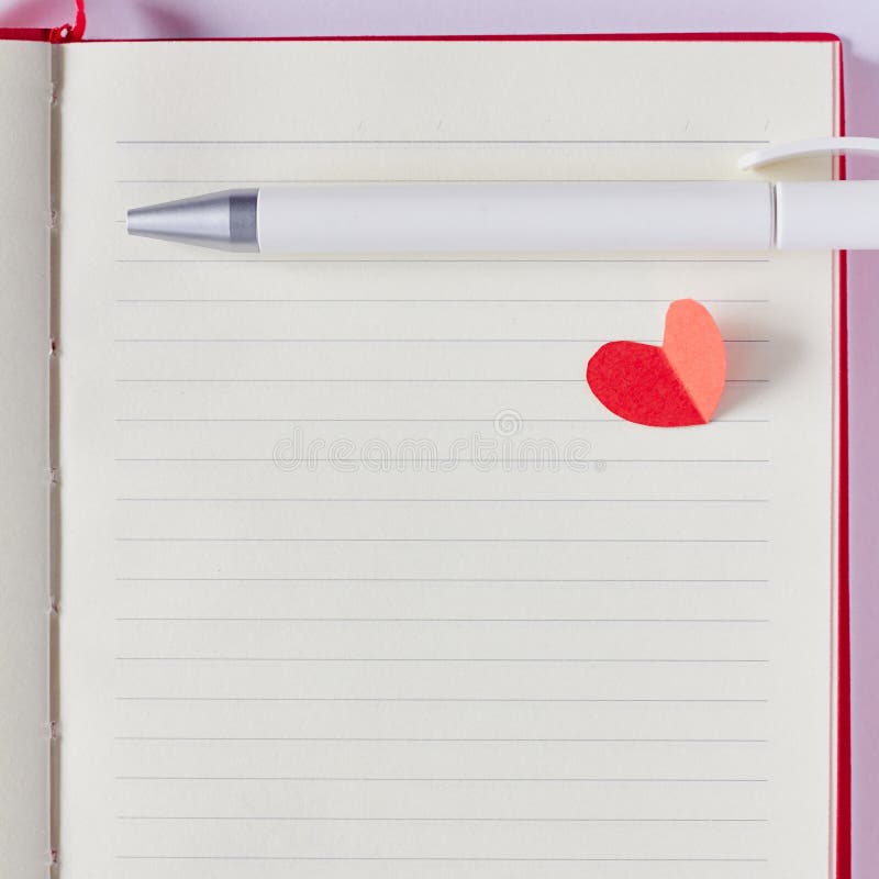 Blank page in notebook, pen and red paper heart