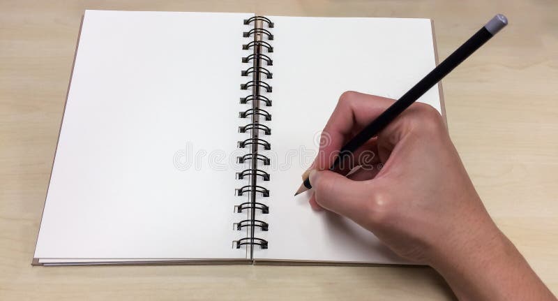 Blank Pages of Open Book with Asian Male Hand Holding Black Pencil ready to Write down